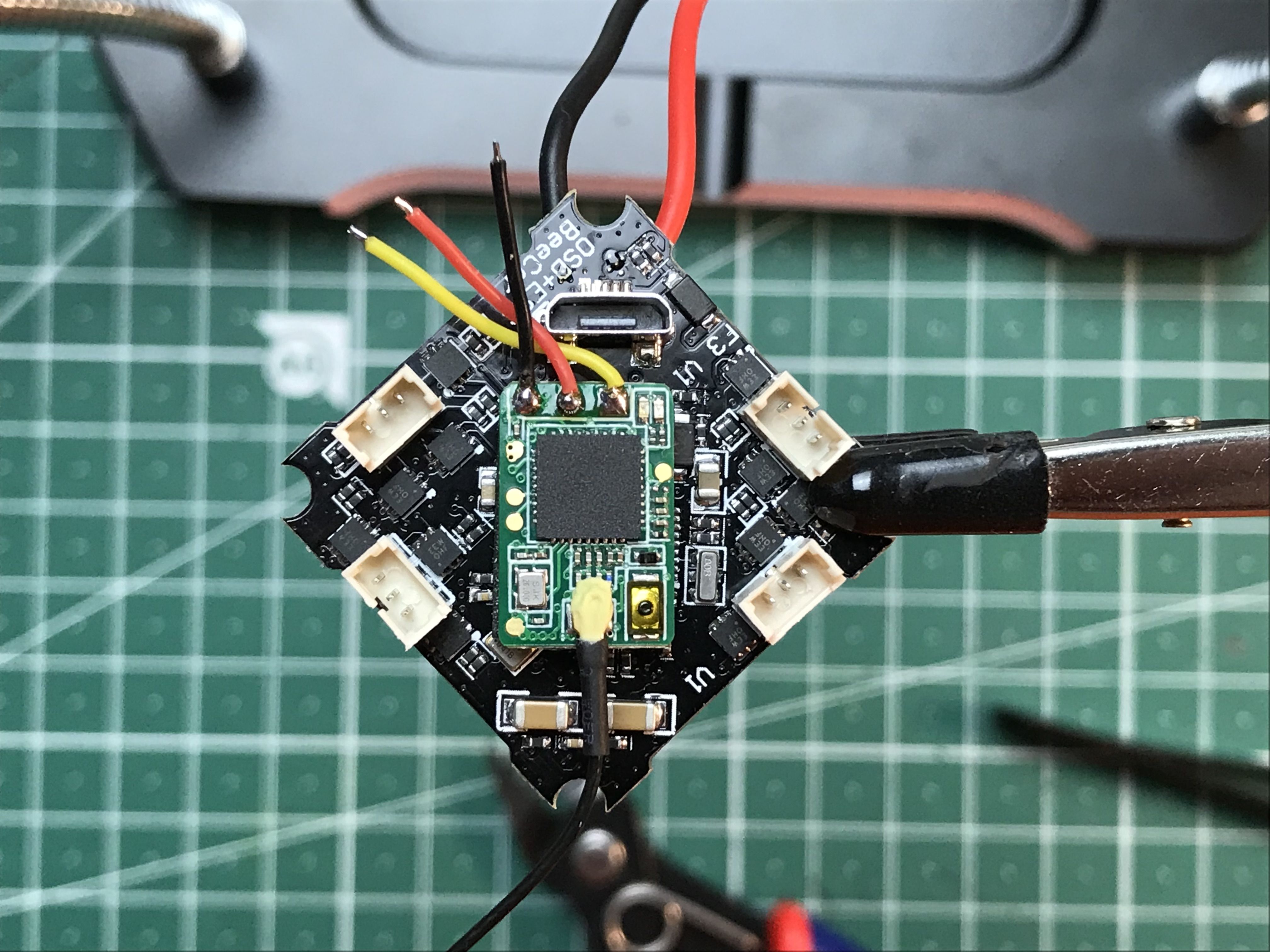 The receiver mounted on the flight controller